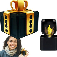 A black gift box with a gold handle and a yellow lightbulb gag inside, shown next to a smiling woman.