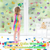 A young child stands in front of a window covered with colorful butterfly and floral stickers, demonstrating a diamond painti