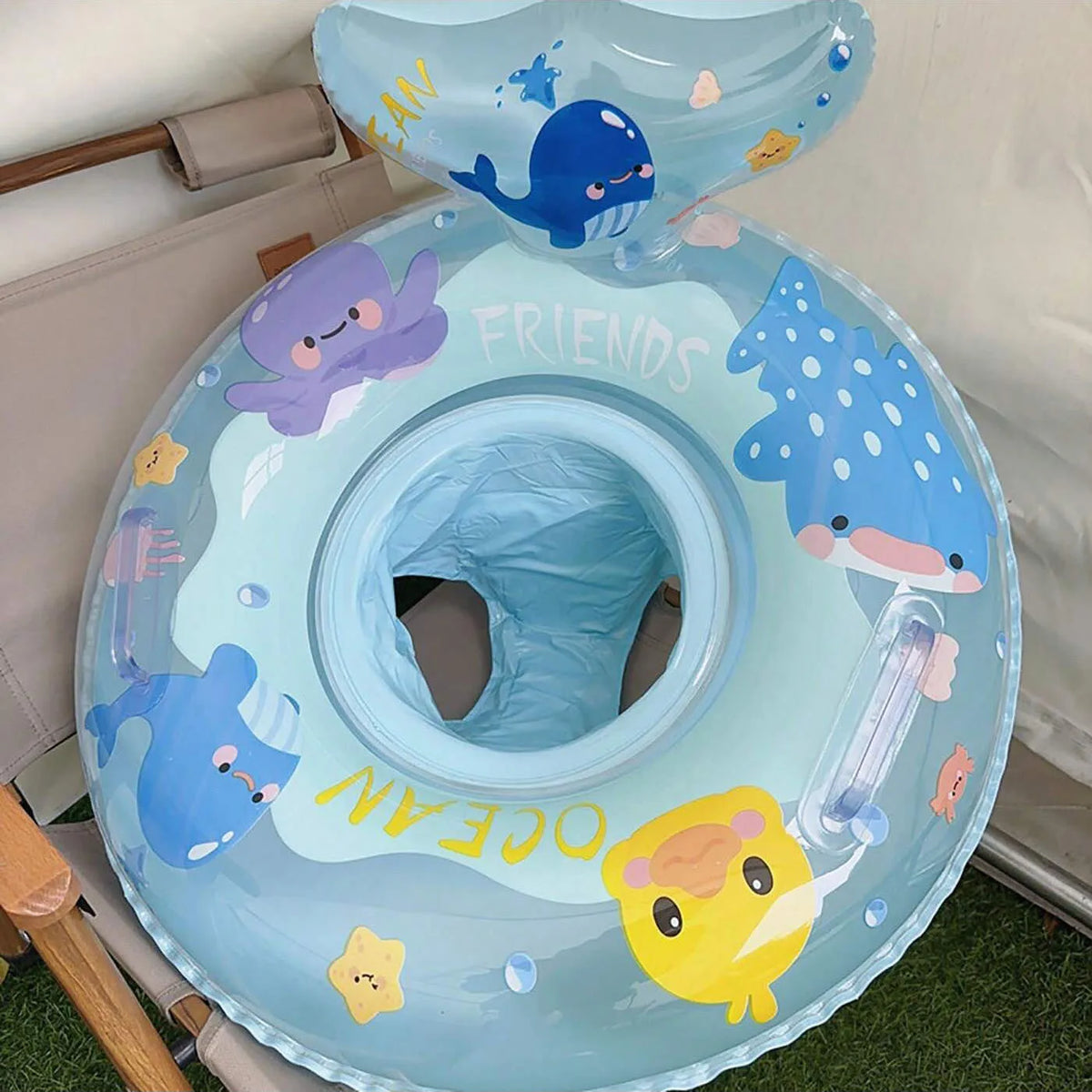 Light blue inflatable baby swim ring featuring sea creatures like a whale and a yellow chick.