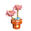 A set of pink and blue City Creativity Building Blocks featuring flower-shaped pieces stacked on an orange base.