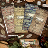 A collection of vintage metal and paper labels, including a brass metal label and various paper labels, displayed on dark woo