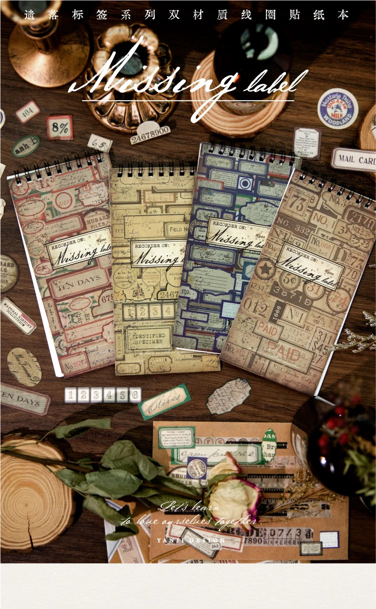 A collection of vintage metal and paper labels, including a brass metal label and various paper labels, displayed on dark woo