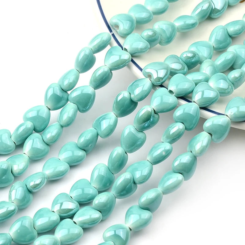 A strand of light blue heart-shaped acrylic beads for jewelry making