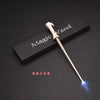 A light-up magic wand with a wooden handle and glowing tip is displayed on a dark surface.