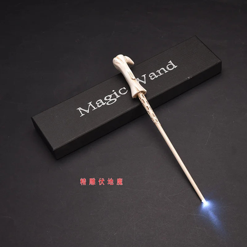 A light-up magic wand with a wooden handle and glowing tip is displayed on a dark surface.