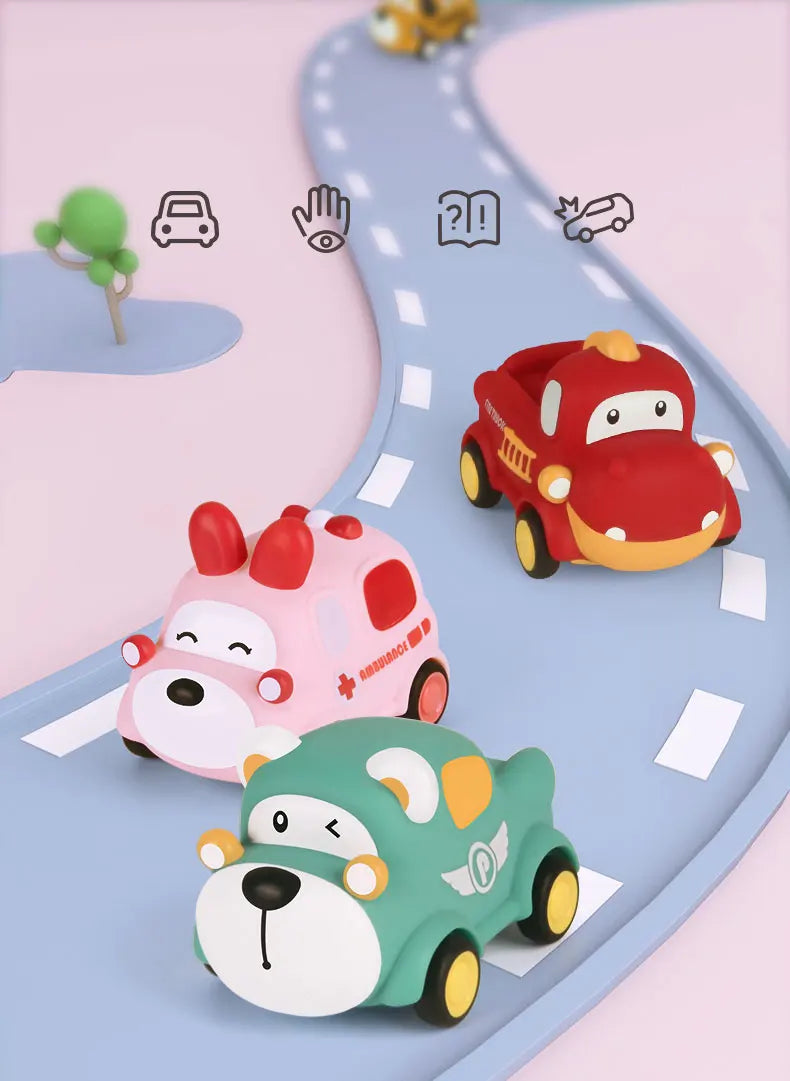A set of soft rubber pull-back toy cars, including a red car and two green/pink animal-themed cars, on a light blue track.