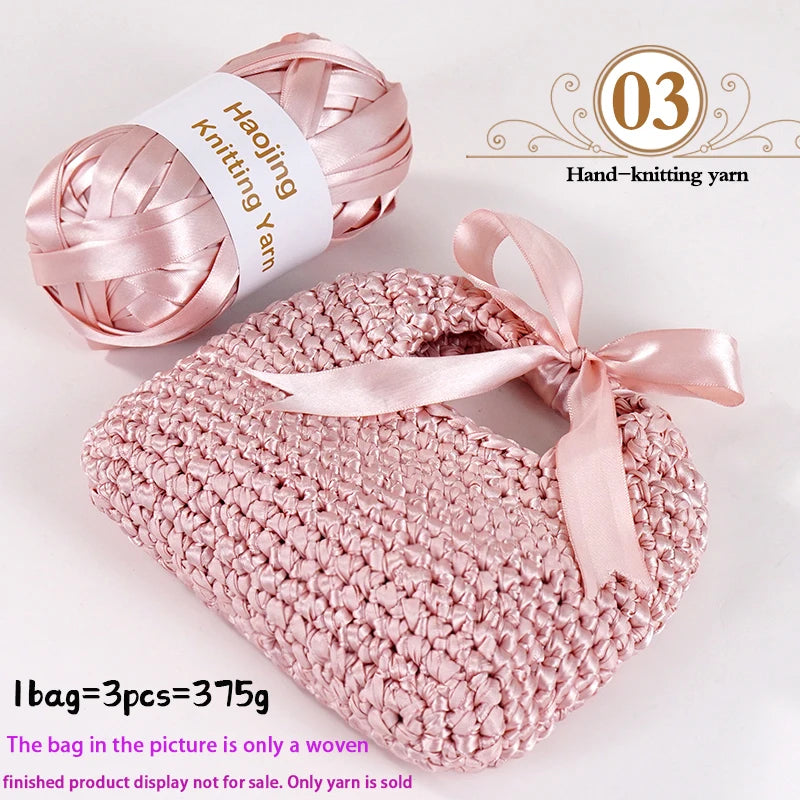 Pink satin ribbon yarn is shown alongside a finished knitted bag made from the yarn.