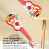 A wooden ukulele toy with colorful decorations and a pink handle is shown resting on a light wood table.