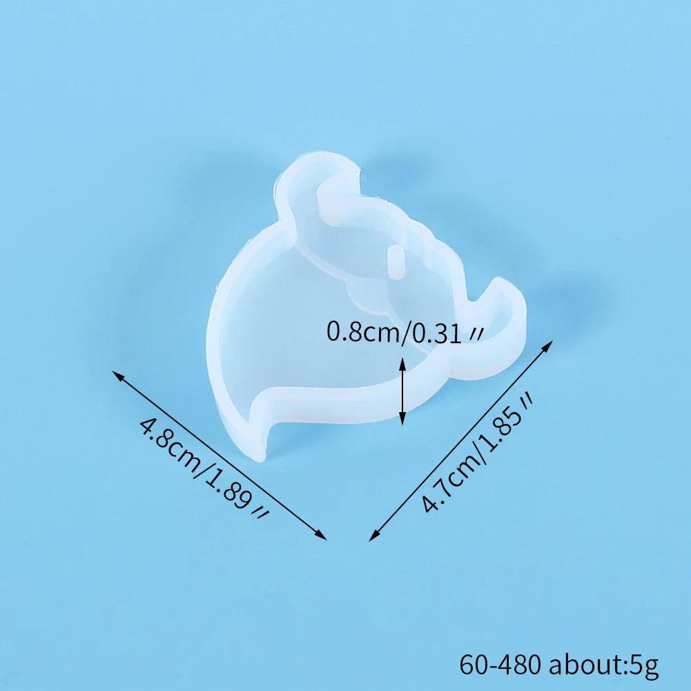 A clear silicone mold shaped like a festive Christmas ornament for jewelry and craft projects.