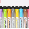 A set of magnetic dry-erase whiteboard markers in various colors including purple, lime green, orange, gray, yellow, blue, br