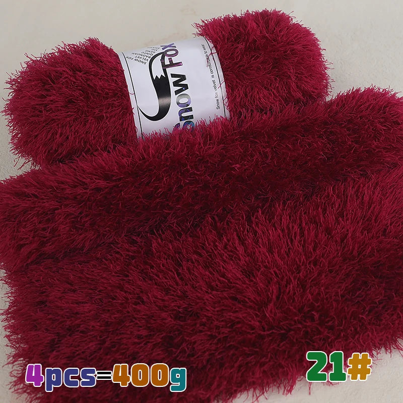 A close-up of a deep red faux fur hat or accessory with a label showing the brand Snow Fox.