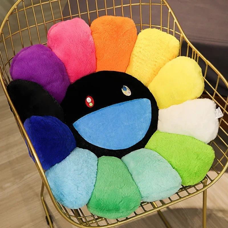 A collection of colorful, fluffy sunflower-themed plush cushions in shades of pink, orange, yellow, purple, and green.