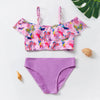 A pink and purple two-piece swimsuit set for girls featuring floral patterns