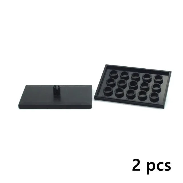 A set of two black motor and servo components for building blocks.