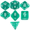 A set of six green acrylic dice showing various numbers and shapes.