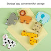 A collection of wooden animal shapes in various colors, including elephants, lions, tigers, and a cow, laid out on a yellow c