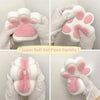 A pair of pink and white squishy cat paw toys are shown being held in gloved hands.