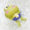 A yellow floating frog bath toy with large eyes and pink accents is submerged in clear water.