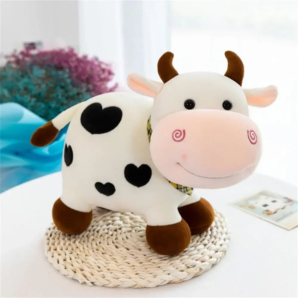 A white cow plush toy with black spots and pink accents sitting on a woven surface.
