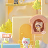 A collection of cute cat figurines and related items displayed in a light yellow and pink themed box set.