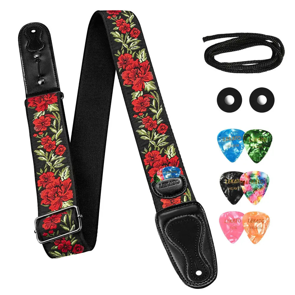 Black guitar strap with red floral pattern, including picks and strap locks.