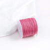 A pink spool of 0.8mm cotton nylon macrame cord for jewelry making and crafts.