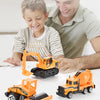 A boy and man look at an orange diecast construction vehicle playset on a white surface.