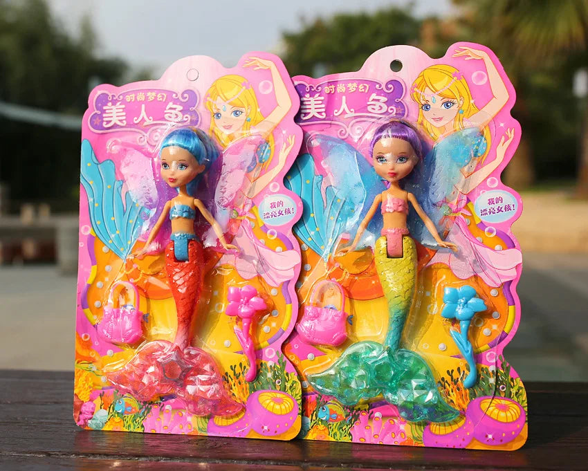 A set of two mermaid princess dolls with pink and blue scales and flowing hair, displayed in colorful packaging.