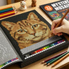 A close-up of a Mystery Mosaics Color by Number book showing a detailed tiger design being colored with paintbrushes.