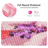 Close-up of a diamond painting featuring various shades of pink, purple, and red stones.