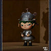 A collectible figurine of a small, stylized character wearing a metal helmet and armor.