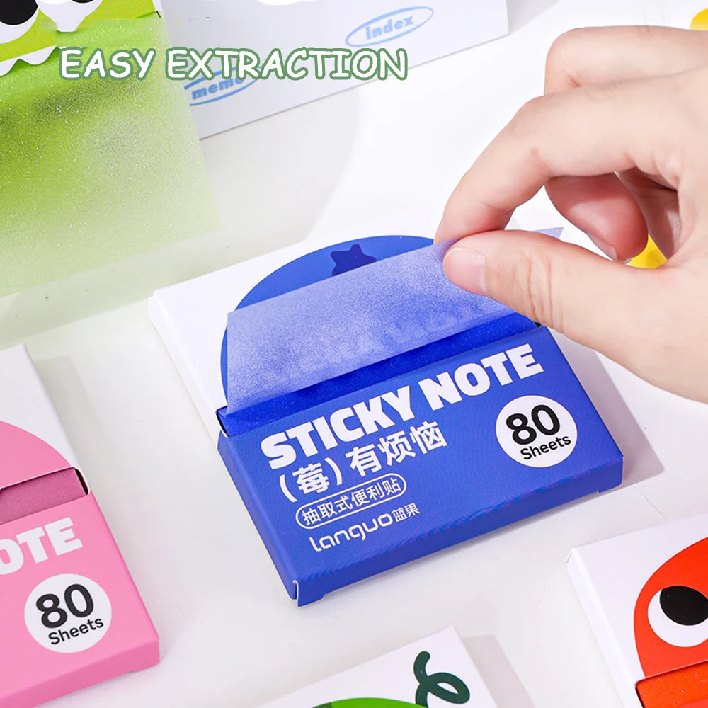 A hand is extracting a blue sticky note from a pull-through dispenser, showing the 80 sheets of pearlescent clear sticky note