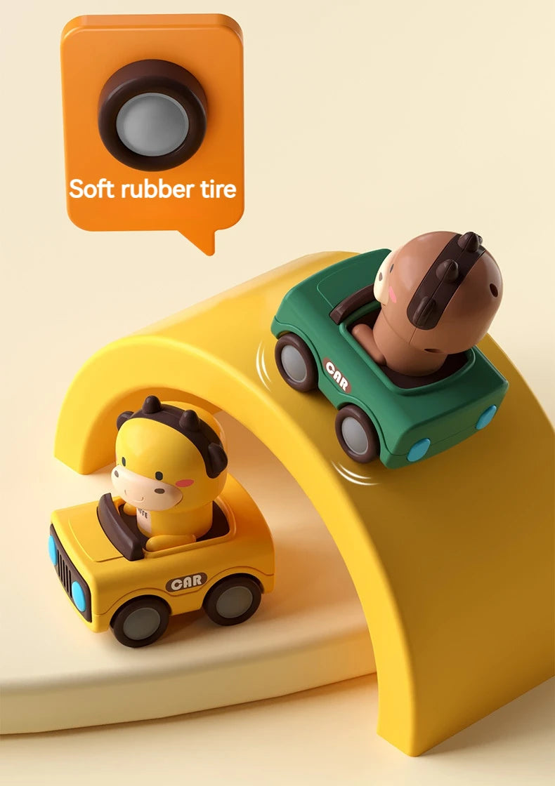 A green animal car toy is shown driving on a yellow push-and-go vehicle, with a soft rubber tire icon nearby.
