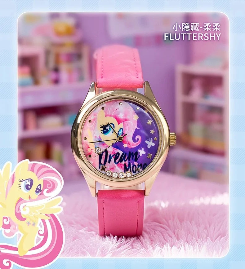 A pink strap watch with a gold casing and a purple dial featuring a unicorn design.