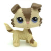 A small, standing dog figure with brown and tan markings and large blue eyes.