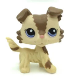 A small, standing dog figure with brown and tan markings and large blue eyes.