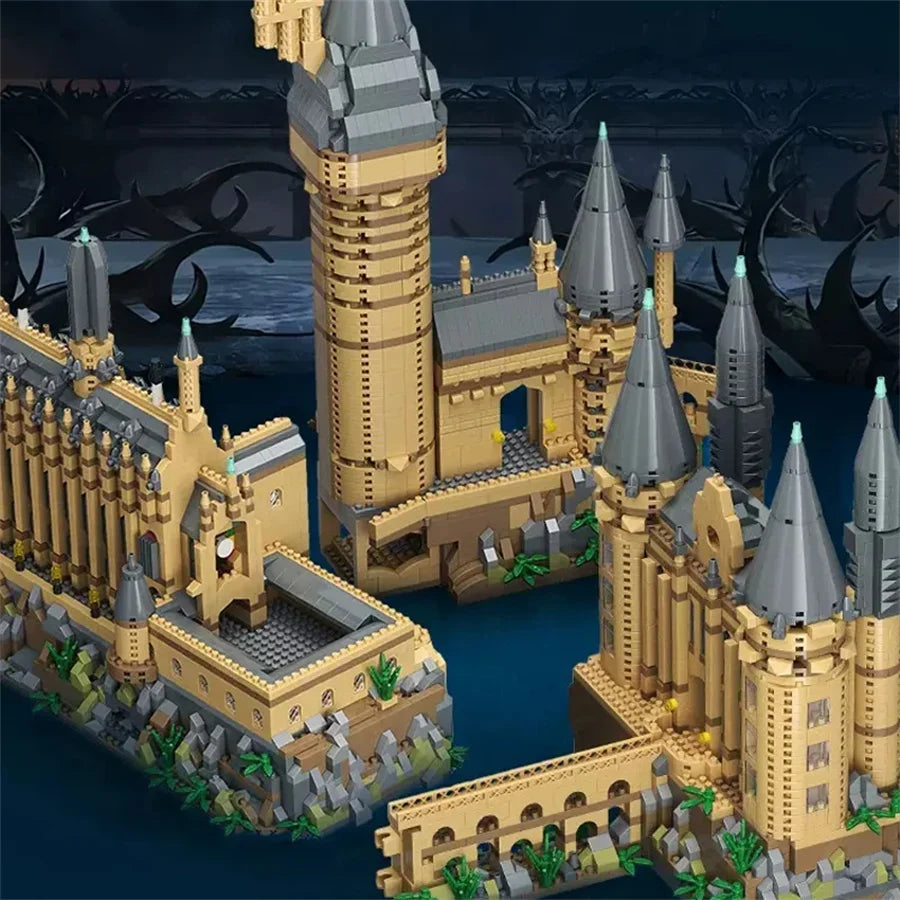 A detailed model of a medieval castle built from tan and gray building blocks on water.