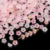 A pile of pink and white gradient bellflower acrylic beads for jewelry making