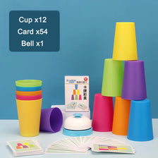 A set of colorful stacking cups, cards, and a bell for a kids game, displayed on a light blue surface.