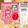 A box of a Gashapon toy machine featuring a pink strawberry character and a red egg twister with six colored eggs.
