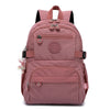 Sac à dos de voyage rose durable avec accents noirs et plusieurs compartiments.
