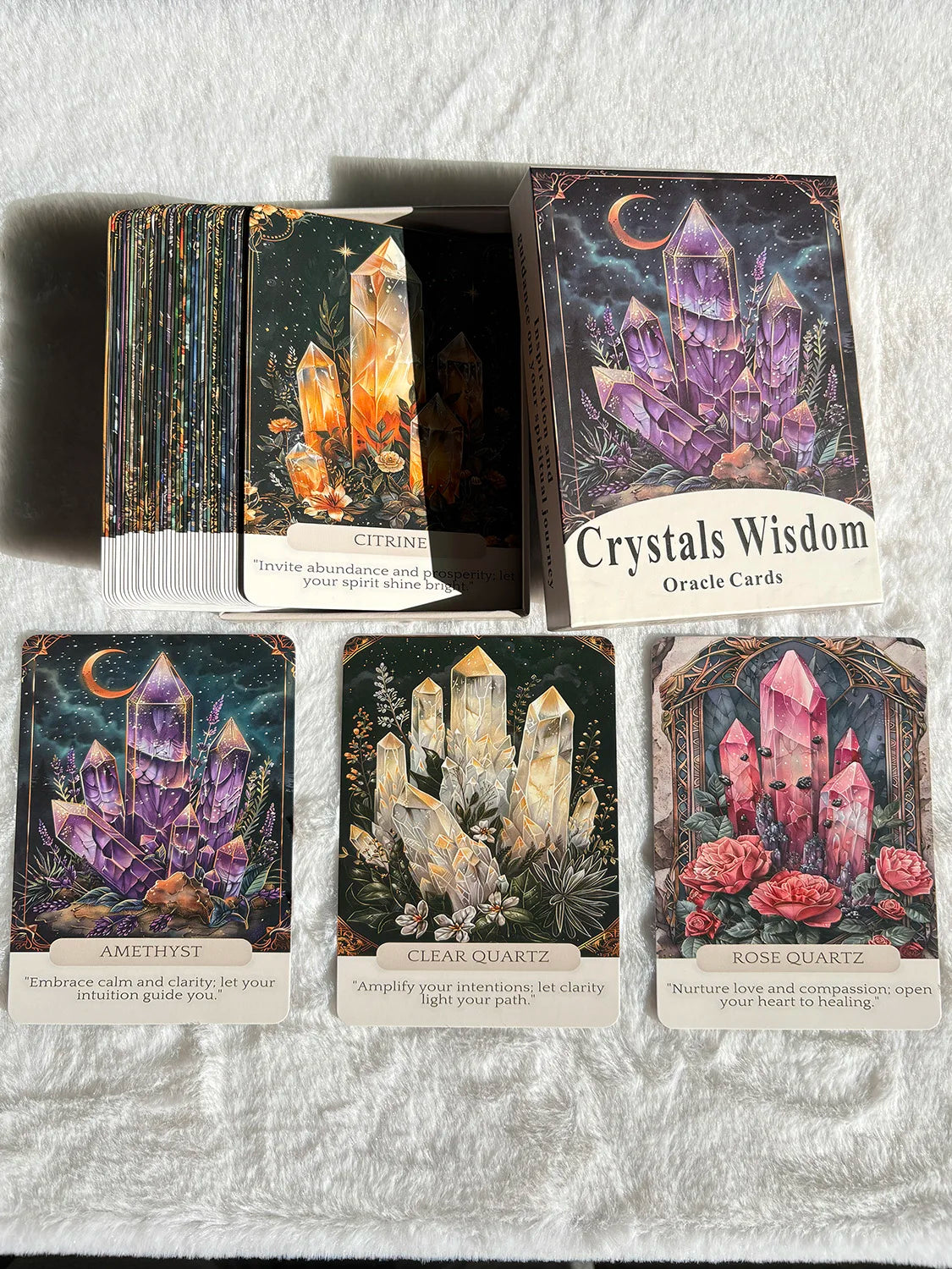 A collection of Crystals Wisdom Oracle Cards featuring amethyst, clear quartz, and rose quartz stones.