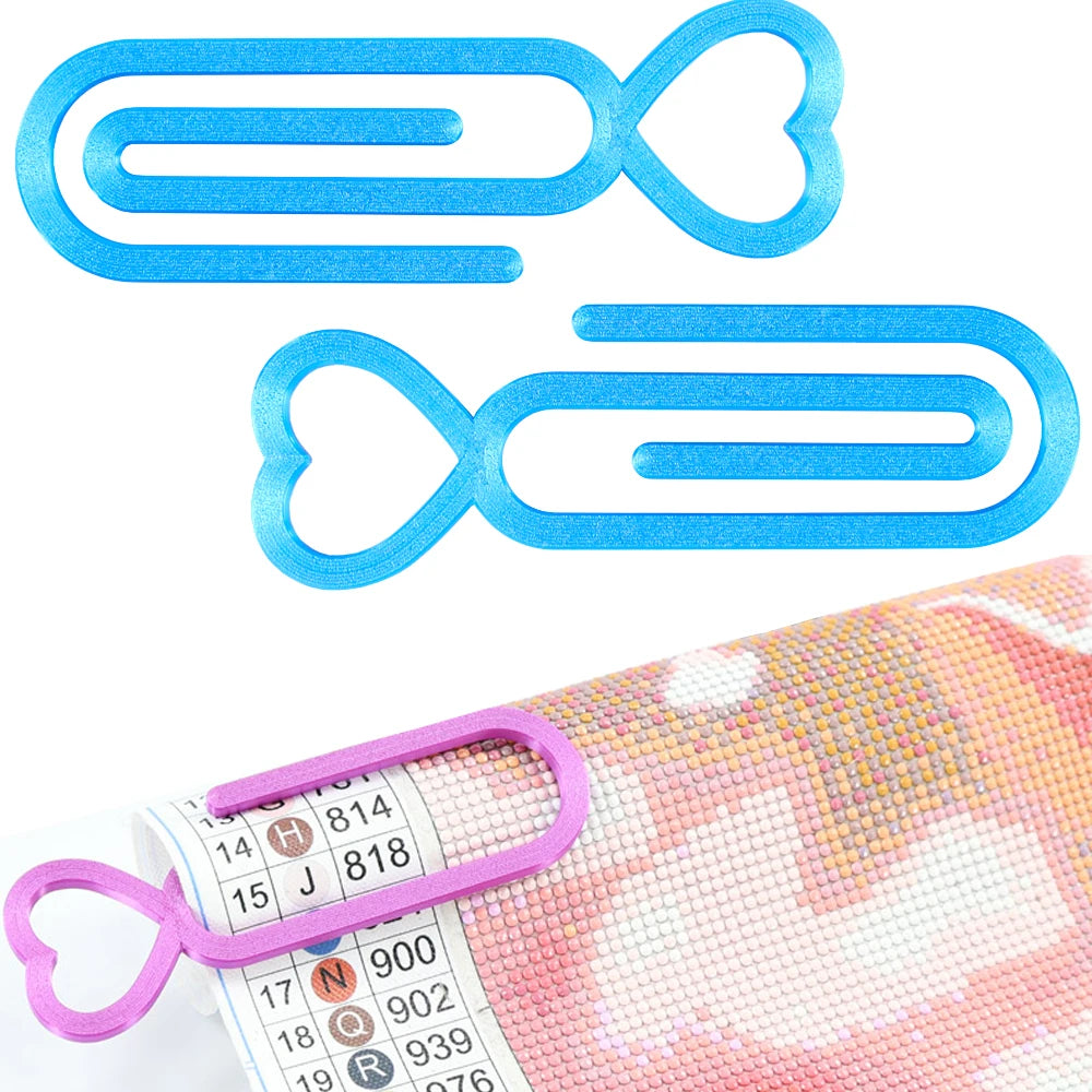 A set of two light blue heart-shaped canvas clips for diamond painting