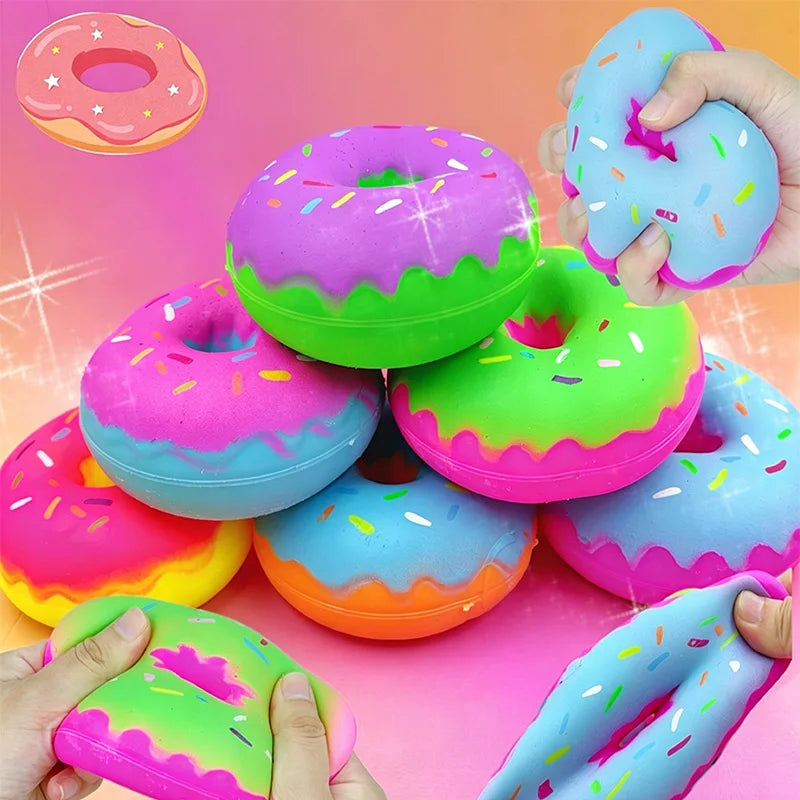 Colorful, squishy cartoon donut squeeze toys in various bright colors are being held by hands.
