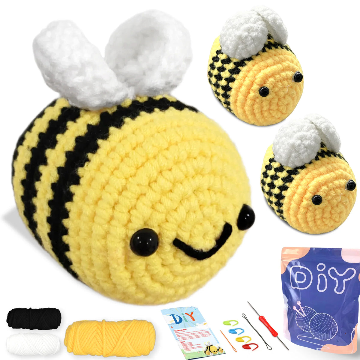 A yellow crocheted bee amigurumi toy with black stripes and large white fuzzy wings, shown next to yarn and tools.