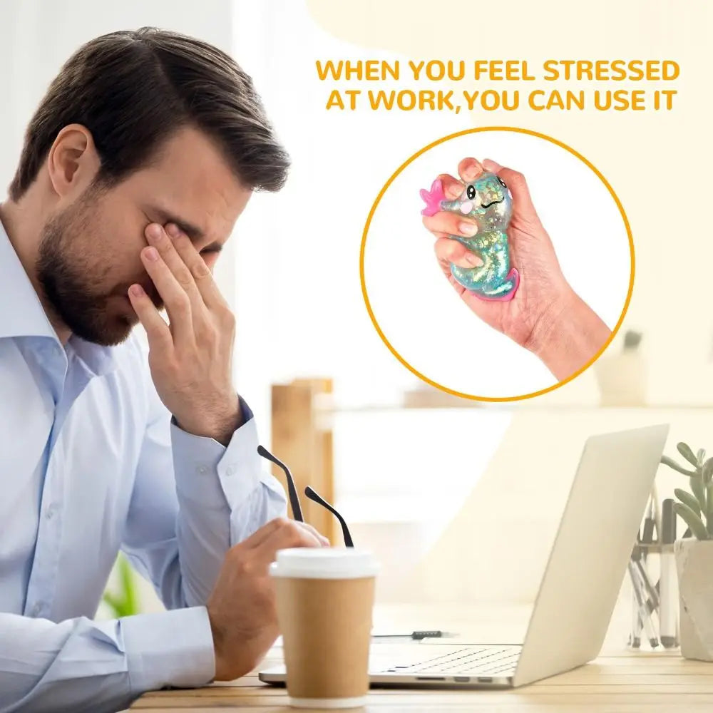 A hand holds a squishy axolotl fidget toy, used to relieve stress at work.