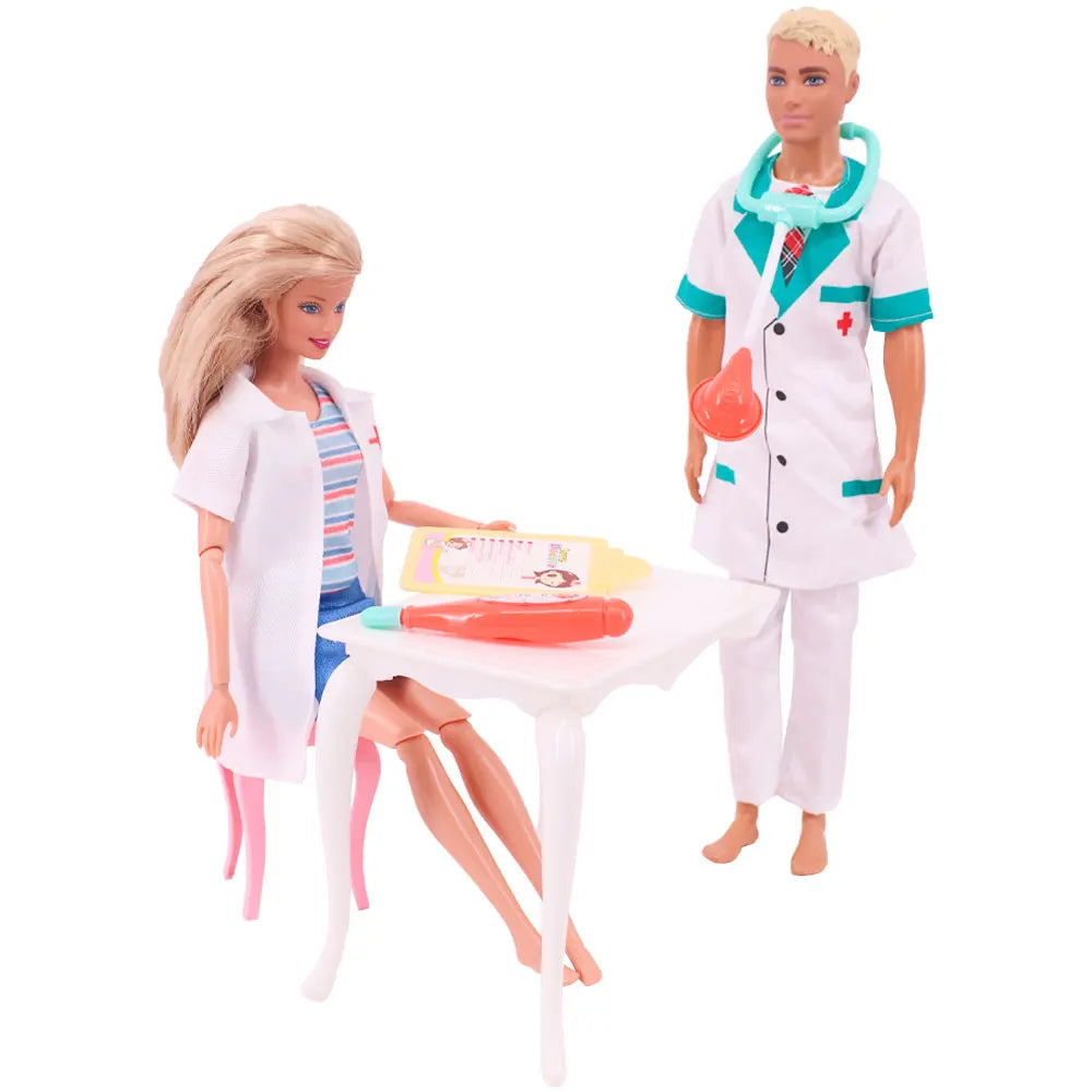 A blonde doll dressed as a doctor wearing a white lab coat and stethoscope stands next to a white table with medical accessor