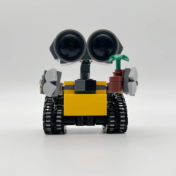A yellow and black building block vehicle with large headlights and green accents.