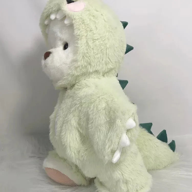 A light green plush teddy bear with spiky accents and a pink nose.