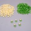 A collection of yellow and green glass beads, including loose beads and small clusters.